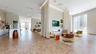 Located at 850 Pacific St in Stamford, Connecticut, this expansive single-floor amenity space offers a refined, modern environment spanning over 5,300 square feet. The layout is thoughtfully organized into distinct yet open zones, creating a seamless flow throughout the space. The grand entrance foyer sets the tone with a striking living green wall mounted against warm wood-paneled walls, patterned tile flooring, and a staircase with sleek glass railings leading to an upper-level overlook. The main lounge area features soaring ceilings, a linear fireplace, curated wall art, and generous seating arrangements that encourage both relaxation and socializing. A glass-walled interior room provides a semi-private gathering or dining area with clear sightlines into the larger space. A dedicated co-working or community table zone includes a live-edge wood communal table surrounded by rattan seating, open shelving, and access to an outdoor terrace. Floor-to-ceiling windows and sliding glass doors flood the interior with natural light and frame panoramic views of the surrounding Stamford skyline, lush greenery, and a spacious exterior terrace furnished for outdoor use. The overall ambiance is bright, contemporary, and welcoming.