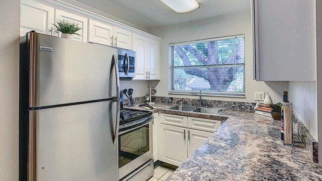 This thoughtfully updated kitchen offers a clean, contemporary design complete with stainless steel appliances, abundant cabinetry, and durable countertops. - Boca Winds