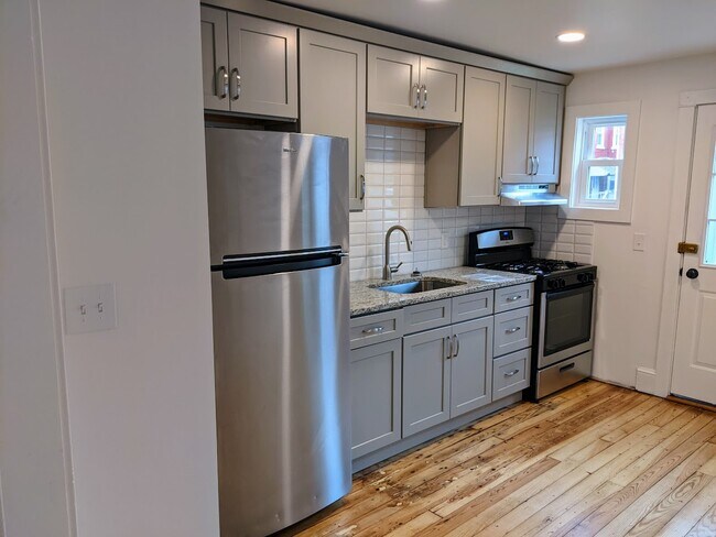 Kitchen with granite counters and tile backsplash - 651 George St