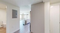 Located at 127 W Pomona Ave in Monrovia, California, this thoughtfully designed 2-bedroom, 2-bathroom residence offers a clean, modern aesthetic across a well-organized single-floor layout. Light wood-tone vinyl plank flooring flows seamlessly throughout, lending a bright and cohesive feel to every room.

The open-concept kitchen and living area serves as the heart of the home, anchored by a sleek white island with ample counter space. The kitchen is outfitted with flat-panel cabinetry in a warm taupe finish, stainless steel appliances including a refrigerator, range, and microwave, and a contemporary sink. Large sliding glass doors and windows allow abundant natural light to fill the space while offering views of surrounding greenery.

The spacious primary bedroom provides a comfortable retreat, featuring a sliding-door closet and a dedicated window that brings in natural light. The second bedroom is similarly well-proportioned, also enjoying a window with outdoor views. Both bedrooms are finished with the same light flooring for a uniform, contemporary look.

The two bathrooms are clean and functional, each featuring light-toned cabinetry, modern fixtures, and a bright vanity mirror. A connecting hallway ties the layout together efficiently. The overall ambiance is calm, minimal, and move-in ready.
