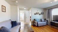 Located at 3936 Pennsylvania Ave in Kansas City, MO, this compact and efficiently designed 2-bedroom, 1-bathroom unit offers a well-organized single-floor layout. The living room features warm hardwood flooring, neutral walls, and a window that brings in natural light, creating a comfortable and welcoming atmosphere. A central hallway connects all rooms, contributing to a logical and easy-to-navigate floor plan.

Both bedrooms are outfitted with hardwood floors and ceiling fans, providing comfort year-round. The primary bedroom benefits from dual windows that allow ample natural light to fill the space. The second bedroom also features a window and includes closet access.

The kitchen is a functional standout, featuring warm oak cabinetry, diagonal tile backsplash, light tile flooring, granite-style countertops, and a full suite of stainless steel appliances including a range, over-the-range microwave, dishwasher, and refrigerator. Track lighting overhead adds a practical touch.

The bathroom includes a wood-cabinet vanity with a single-basin sink, an oval mirror, and a combination tub and shower. The overall aesthetic throughout the unit is clean and neutral, making it a practical and move-in ready space.