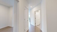 Located at 622 Merritt Ave in Nashville's vibrant 37203 corridor, this well-appointed two-bedroom, two-bathroom residence offers a thoughtfully designed single-level floor plan with clean, modern finishes throughout. The open-concept living and kitchen area serves as the heart of the home, anchored by a central island with a stainless steel sink and dishwasher, pendant lighting, and light wood-look flooring. Expansive floor-to-ceiling windows and sliding glass doors flood the space with natural light while framing sweeping views of the Nashville skyline and surrounding tree canopy. A ceiling fan completes the airy, comfortable atmosphere. The primary bedroom is a well-sized retreat featuring tall windows with abundant natural light and city views, complemented by its own dedicated closet. The second bedroom mirrors this bright aesthetic, with large windows overlooking lush treetops. Each bathroom is finished with neutral large-format tile flooring. The primary bath features a glass-enclosed walk-in shower with subway tile surround, while the secondary bath offers a tiled soaking tub and shower combination with a light wood vanity and white quartz countertop. A central hallway connects all rooms efficiently, with two closets providing ample storage. Crisp white walls and consistent flooring tie the entire residence together cohesively.
