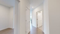 Located at 622 Merritt Ave in Nashville's vibrant 37203 corridor, this well-appointed two-bedroom, two-bathroom residence offers a thoughtfully designed single-level floor plan with clean, modern finishes throughout. The open-concept living and kitchen area serves as the heart of the home, anchored by a central island with a stainless steel sink and dishwasher, pendant lighting, and light wood-look flooring. Expansive floor-to-ceiling windows and sliding glass doors flood the space with natural light while framing sweeping views of the Nashville skyline and surrounding tree canopy. A ceiling fan completes the airy, comfortable atmosphere. The primary bedroom is a well-sized retreat featuring tall windows with abundant natural light and city views, complemented by its own dedicated closet. The second bedroom mirrors this bright aesthetic, with large windows overlooking lush treetops. Each bathroom is finished with neutral large-format tile flooring. The primary bath features a glass-enclosed walk-in shower with subway tile surround, while the secondary bath offers a tiled soaking tub and shower combination with a light wood vanity and white quartz countertop. A central hallway connects all rooms efficiently, with two closets providing ample storage. Crisp white walls and consistent flooring tie the entire residence together cohesively.