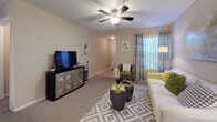 Located at 1589 Starlight Cv in Tarpon Springs, Florida, this single-story home offers a well-organized layout with a warm, neutral color palette throughout. The living room provides a welcoming gathering space with plush carpeting, a ceiling fan, and a large window dressed in patterned curtains that invite natural light. The kitchen is equipped with warm oak cabinetry, dark granite-style countertops, a gas range, and a full-size refrigerator, with tile flooring that adds durability and easy maintenance. Multiple bedrooms accommodate a variety of needs — the primary bedroom features carpet flooring, a ceiling fan, and direct access to an en-suite bathroom with a wood vanity and granite countertop. Additional bedrooms include natural light from windows with outdoor views, ceiling fans, and carpet flooring, with one room functioning flexibly as a home office or lounge space. The bathrooms are finished with tile flooring, wood vanities with dark countertops, and tub-shower combinations. Throughout the home, consistent neutral tones, ceiling fans in every room, and an abundance of natural light from well-placed windows create a cohesive, comfortable living environment suited to Florida's sunny climate.