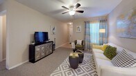Located at 1589 Starlight Cv in Tarpon Springs, Florida, this single-story home offers a well-organized layout with a warm, neutral color palette throughout. The living room provides a welcoming gathering space with plush carpeting, a ceiling fan, and a large window dressed in patterned curtains that invite natural light. The kitchen is equipped with warm oak cabinetry, dark granite-style countertops, a gas range, and a full-size refrigerator, with tile flooring that adds durability and easy maintenance. Multiple bedrooms accommodate a variety of needs — the primary bedroom features carpet flooring, a ceiling fan, and direct access to an en-suite bathroom with a wood vanity and granite countertop. Additional bedrooms include natural light from windows with outdoor views, ceiling fans, and carpet flooring, with one room functioning flexibly as a home office or lounge space. The bathrooms are finished with tile flooring, wood vanities with dark countertops, and tub-shower combinations. Throughout the home, consistent neutral tones, ceiling fans in every room, and an abundance of natural light from well-placed windows create a cohesive, comfortable living environment suited to Florida's sunny climate.