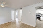 Located at 5420 NW 27th St in Lauderhill, FL, this 2-bedroom, 1-bathroom single-story home offers a clean, contemporary design with a bright and airy atmosphere throughout. Light-toned wood-look tile flooring flows seamlessly across the entire home, creating a cohesive and modern aesthetic.

The combined living and dining area provides a comfortable, open gathering space, featuring a ceiling fan and flush-mount lighting. Natural light filters in through windows fitted with horizontal blinds, lending a welcoming ambiance. An in-unit laundry closet with a stacked washer and dryer is conveniently accessible from the main living area.

The kitchen is a standout feature, showcasing white shaker-style cabinetry, granite countertops, a stainless steel sink, and a mosaic tile backsplash with a subtle geometric pattern. A window above the sink adds natural light to the workspace, and stainless steel appliances complete the modern look.

Both bedrooms are well-proportioned, each offering natural light through sizable windows with exterior views. The spacious primary bedroom includes two closets, one of which features wire shelving for organized storage. The full bathroom is neatly appointed with a wood-toned vanity, framed mirror, and a combined tub and shower with clean white tile surround.