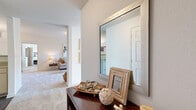 This single-floor residence in Shreveport, Louisiana features a thoughtfully designed layout across two bedrooms and two bathrooms. The entryway welcomes visitors with a decorative console table and a large framed mirror, setting a clean, neutral tone that carries throughout the home. Soft carpet flooring flows through the living and sleeping areas, while wood-style hard flooring is featured in the kitchen and bathrooms.

The open living area is bright and comfortable, with a large window allowing natural light to fill the room. It connects seamlessly to a dedicated dining space, which features a pendant light fixture overhead and easy pass-through access to the kitchen. The kitchen is efficiently arranged with light wood cabinetry, ample counter space, a double basin sink, and a full suite of appliances including a refrigerator, dishwasher, and built-in microwave.

The spacious primary bedroom offers generous proportions, a ceiling fan, and a window with outdoor views, providing a calm and restful retreat. The second bedroom is equally well-sized and versatile. Both bathrooms are clean and functional, with one featuring a bathtub-shower combination, wood-style flooring, and built-in cabinetry for storage. Throughout the home, neutral wall tones and consistent finishes create a cohesive and inviting atmosphere.