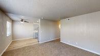 Located at 315 W Alamos Ave in Clovis, CA, this 2-bedroom, 1-bathroom unit offers a well-designed single-level layout with a thoughtful mix of hard flooring and plush carpet throughout. The living room is a comfortable, carpeted space anchored by a ceiling fan and a large window fitted with blinds that frame views of surrounding greenery, filling the room with natural light. A front entry door opens directly into this welcoming area. The kitchen is a standout feature, showcasing gray shaker-style cabinetry, light stone-look countertops, a stainless steel refrigerator, stove, and a single-basin sink — all set atop light wood-look vinyl flooring. The kitchen flows seamlessly into a dedicated dining area, also finished with vinyl flooring and brightened by a window and ceiling fan. Both bedrooms are carpeted and neutral in tone, providing a calm and restful atmosphere. The primary bedroom includes sliding glass doors that open to a private balcony. The bathroom is clean and modern, featuring a sliding-glass tub/shower enclosure, a vanity with stone-look countertop, and wood-look vinyl flooring. Three closets and two utility spaces provide ample storage throughout. Textured ceilings are consistent across the unit.