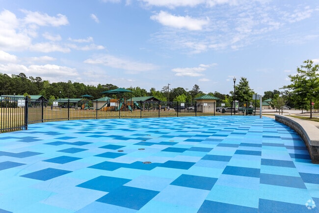 Children play in the water at Ellenwood's Village Park splash pad.