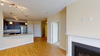 Located on the fourth floor at 3320 Galena Dr in Frederick, MD, this single-level residence offers a thoughtfully designed layout with a clean, contemporary aesthetic throughout. The open living area is a standout feature, showcasing warm hardwood flooring, a gas fireplace with a classic white mantel, and track lighting that adds a modern touch. The space flows naturally into the kitchen and adjoining rooms, creating a cohesive and functional floor plan.

The kitchen is well-equipped with rich dark espresso cabinetry, granite countertops, stainless steel appliances including a range, built-in microwave, and a full-size refrigerator, complemented by a double basin sink. The hardwood floors continue seamlessly from the living area into the kitchen.

The bedrooms feature plush wall-to-wall carpeting and large windows that invite natural light and offer views of the surrounding greenery and neighborhood. The unit includes two full bathrooms, each finished with tile flooring, dark vanity cabinetry, white countertops, and a tub/shower combination with white subway tile surround. Both bathrooms are accented with brushed nickel fixtures and well-lit vanity mirrors. The overall color palette of warm beige tones throughout lends the space a bright, neutral, and move-in-ready ambiance.