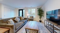 This thoughtfully designed 2-bedroom, 1-bathroom unit in California offers a modern, single-floor layout with a clean, contemporary aesthetic throughout. Light wood laminate flooring flows seamlessly across all rooms, creating a cohesive and airy feel.

The open-concept living area is bright and welcoming, featuring large windows and a glass-panel entry door that allow generous natural light to fill the space. A charming barn-style sliding door adds a distinctive architectural touch connecting the living area to the rest of the unit.

The kitchen is efficiently designed with a galley-style layout, featuring two-tone cabinetry — white upper cabinets paired with warm wood lower cabinets — complemented by a white quartz countertop, subway tile backsplash, and a full suite of stainless steel appliances including a range, microwave, dishwasher, and refrigerator.

Both bedrooms are finished with crisp white walls and light flooring. The primary bedroom includes a window with an exterior view and a sliding-door closet, while the second bedroom connects conveniently to the hallway. The bathroom features a full tub-shower combination with elegant large-format marble-look tile surround and chrome fixtures, offering a clean and polished finish throughout.
