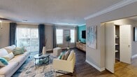 This single-floor residence at 8325 University Station Circle in Charlotte, NC offers a well-designed layout with distinct living spaces finished in a cohesive neutral and teal color palette. Wood-style flooring runs throughout, complemented by textured ceilings and crown molding in the main living areas.

The living room features a ceiling fan, crown molding, and vertical blinds allowing natural light, while an adjacent sitting area provides additional flexible space with dual windows overlooking the exterior. The dining area is defined by a pendant light fixture, framed wall art, and crown molding, creating an intimate yet open setting.

The kitchen is outfitted with white shaker-style cabinetry, granite-look countertops, stainless steel appliances including a refrigerator and dishwasher, and a double-basin sink.

The bedrooms feature bold teal accent walls, wood-style flooring, ceiling fans, and windows with blinds and patterned curtains that allow ample natural light. Two bathrooms serve the unit: one with a white vanity, marble-look countertop, and a tub/shower combination with wood-tiled surround, and a second with a granite-top vanity and brushed nickel fixtures throughout.