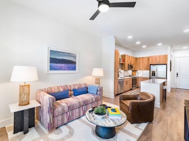Experience the allure of Modera Trinity's dynamic floor plans, where gourmet kitchens boast quartz countertops, 42-inch custom cabinetry, vibrant under-cabinet lighting, and an open layout that effortlessly flows into the living area. - Modera Trinity