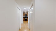 Located on the 14th floor at 115 Christina Landing Dr in Wilmington, Delaware, this one-bedroom, one-bathroom unit offers a thoughtfully laid-out single-floor plan. Light hardwood flooring flows consistently throughout the living room, bedroom, and hallway, lending the space a warm and cohesive feel.

The open living area is bright and airy, featuring clean white walls, a textured ceiling, and a sliding glass door that leads to a private balcony with outdoor views. A pendant light fixture adds a subtle design touch to the space.

The kitchen is functionally equipped with warm honey-toned wood cabinetry, dark granite-style countertops, and black appliances including an electric range and an over-the-range microwave, providing ample storage and prep space.

The bedroom is a well-proportioned retreat with a large window that draws in natural light and offers exterior views. It features access to a dedicated closet with built-in shelving, providing convenient storage solutions.

The bathroom maintains a consistent design palette with tile flooring, a wood vanity with dark countertop, a framed mirror, and clean white walls. A hallway and additional closet complete the layout, enhancing the overall functionality of this well-organized unit.