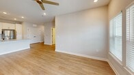 Located at 5001 Willowgate Loop in Fort Myers, FL, this 1-bedroom, 1-bathroom home offers a thoughtfully designed single-level layout with modern finishes throughout. The open-concept kitchen and living area serves as the heart of the home, featuring light wood-look flooring, recessed lighting, and a ceiling fan that enhances airflow and comfort. The kitchen is well-appointed with crisp white shaker cabinetry, a subway tile backsplash, stone-look granite countertops, a center island with a double-basin sink, and a full suite of stainless steel appliances including a refrigerator, range, and over-the-range microwave. The living area flows seamlessly from the kitchen, with large windows fitted with blinds that invite natural light. The bedroom is carpeted for comfort and includes a ceiling fan, a window with outdoor views, and access to two closets for ample storage. The bathroom mirrors the home's clean aesthetic with white cabinetry, granite countertops, and matching black hardware accents. Additional conveniences include a dedicated laundry area and an attached garage with an automatic opener, providing secure parking and extra storage space.