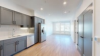Located at 6010 Alpine Vista Cir in Castle Rock, CO, this thoughtfully designed one-bedroom, one-bathroom residence offers a clean, modern aesthetic throughout its efficiently organized single-floor layout. Light hardwood flooring runs through the main living areas, complementing the bright, white walls and recessed lighting that create a fresh, airy ambiance.

The kitchen is a standout feature, outfitted with slate-gray shaker-style cabinetry, white subway tile backsplash, white quartz countertops, and a full suite of stainless steel appliances including a French door refrigerator, range, microwave, and dishwasher. The kitchen flows seamlessly into the open living room, which is bathed in natural light from large windows and offers access to a private balcony overlooking the surrounding neighborhood.

The bedroom is a comfortable retreat, featuring plush carpet, a ceiling fan, and a generous window with outdoor views. A stylish sliding barn door connects the bedroom to the bathroom and closet, adding a contemporary architectural detail. The full bathroom is finished with matching gray cabinetry, a white vanity, and a tiled shower-tub combination. A dedicated closet completes the private quarters, providing practical everyday storage.