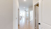 Located at 17000 Bissonnet Street in Richmond, TX, this 2-bedroom, 1-bathroom single-floor home offers a well-designed layout with a clean, modern aesthetic throughout. Light wood-look flooring flows seamlessly across every room, complemented by crisp white walls and recessed lighting that keep the space feeling bright and open.

The kitchen serves as the heart of the home, featuring a central island with a built-in sink, white quartz countertops, light wood cabinetry, and a full suite of stainless steel appliances including a refrigerator, range, and microwave. Dramatic black pendant lights hang above the island, adding a contemporary accent. The kitchen opens directly into the living area, which is equipped with a ceiling fan and benefits from natural light through multiple windows.

The primary bedroom is a comfortable, well-proportioned space with a ceiling fan, large windows with outdoor views, and direct access to the full bathroom. The bathroom features a floating vanity with a large mirror and dedicated storage. The second bedroom also features light-filled windows and a double-door closet. With five closets total, storage is a notable strength throughout the home. Additional highlights include a dedicated laundry room with washer and dryer hookups and a private balcony accessible from the main living area.