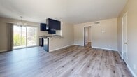 Located at 2841 Montrose Ave in Glendale, CA, this 2-bedroom, 1-bathroom unit offers a thoughtfully designed single-floor layout. Light wood-style vinyl flooring runs throughout, lending a clean, cohesive look to the entire space. The open-concept living and kitchen area forms the heart of the unit, with the living room bathed in natural light from a large front-facing window and a sliding glass door that brings in additional brightness. A breakfast bar with a shelved counter connects the kitchen to the living area, creating an inviting flow. The kitchen is well-equipped with dark espresso cabinetry, granite-style countertops, a stainless steel sink, and an electric range with an overhead exhaust hood. The primary bedroom features dual corner windows with curtains, offering pleasant outdoor views of the surrounding neighborhood and greenery. The second bedroom includes a built-in closet with a rod and shelf. The bathroom is outfitted with a sliding glass tub-shower enclosure, a window for natural light, and matching light flooring. Neutral warm-beige walls and clean white trim throughout give the space a bright, move-in-ready feel. Central HVAC with visible ceiling vents ensures year-round comfort throughout the unit.