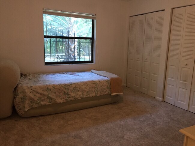 Another view of the master bedroom, taken from the bathroom door. (Please ignore the twin bed – it’s temporary and will leave before you arrive.) - 1101 SW 20th Place