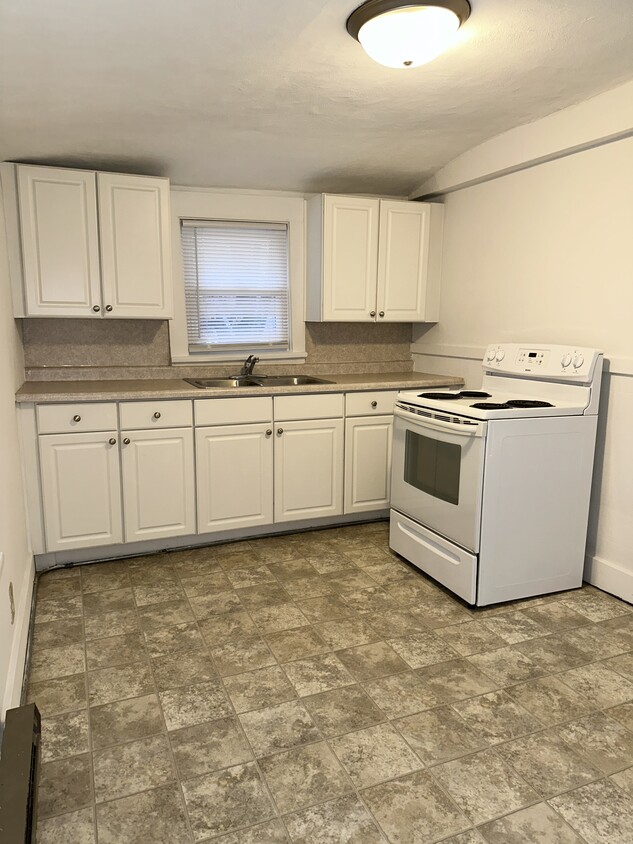 Large kitchen. Stove & Fridge/freezer provided. Plenty of room for a table. - 803 W Edwards St