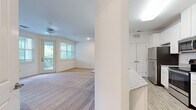 Located at 308 Mohegan Ave in Bluffton, South Carolina, this single-floor residence offers a thoughtfully designed layout across two bedrooms and two bathrooms. The open-concept kitchen and living area form the heart of the home, where light-toned walls and neutral carpeting create a bright, welcoming atmosphere throughout.

The kitchen is well-equipped with stainless steel appliances, including a full-size refrigerator, range, and microwave. White beadboard cabinetry extends to the ceiling, providing ample storage, while granite countertops and a peninsula with an undermount sink add both style and functionality. Light wood-look flooring grounds the space with a clean, modern aesthetic.

The spacious living room benefits from multiple windows and a glass door that opens to a private balcony, allowing generous natural light and outdoor views of surrounding greenery. The carpeted bedrooms are comfortably sized, each featuring windows with wooded views and ceiling fans. The generously proportioned primary bedroom includes a walk-in closet with wire shelving and hardwood-style flooring.

Both bathrooms are finished with granite countertops, white cabinetry, and undermount sinks, maintaining a consistent, polished look throughout the home.