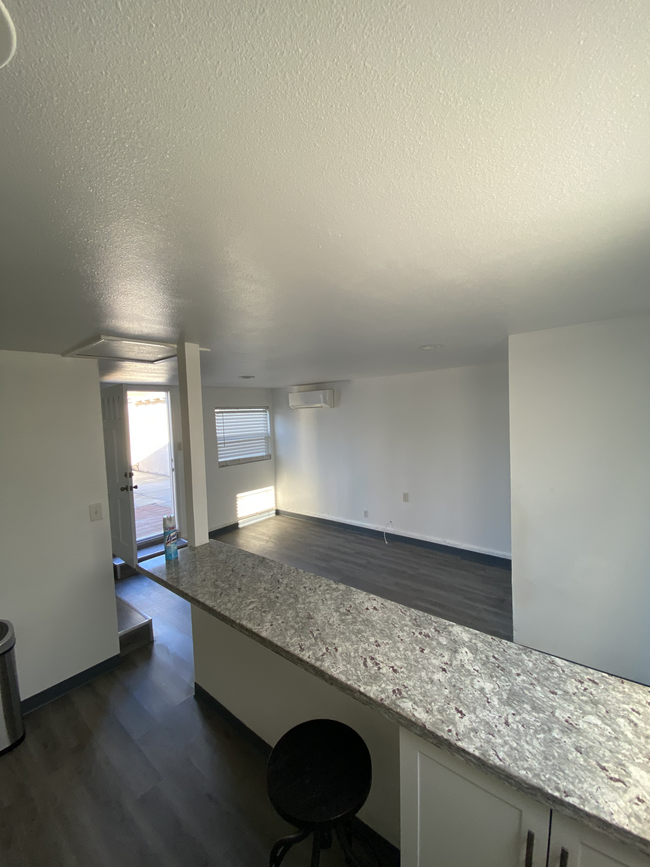 A view from the kitchen by the fridge, over the bar top. - 1911 W 94th St