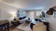 Located at 600 Front Street in San Diego, Unit 1E presents a thoughtfully designed single-floor residence that seamlessly blends functionality with modern style. The open-concept layout connects the kitchen directly to the living and dining areas, creating a cohesive, social space ideal for everyday living.

The kitchen features white shaker cabinetry, stainless steel appliances including a double oven range, built-in microwave, and refrigerator, all complemented by white quartz countertops and a stainless steel sink. Wood-style flooring flows throughout, adding warmth and continuity across the space.

The living area is generously proportioned, featuring a ceiling fan, large window with adjustable blinds for natural light control, and ample room for a full seating arrangement and dining setup.

The bedroom offers a comfortable retreat with neutral-toned walls, a mirrored sliding-door closet providing practical storage, and a window that introduces natural light. The bathroom is finished with white cabinetry, a tall linen tower for additional storage, a white quartz vanity, and a framed mirror, delivering a clean and polished aesthetic throughout.