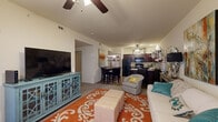 Located at 2501 SW Fireblaze Ave in Bentonville, AR, this single-story, 3-bedroom, 2-bathroom home offers a well-designed open-concept layout that seamlessly connects the living room, dining area, and kitchen. The living room features vaulted ceilings with a ceiling fan and large windows that invite natural light, creating an airy and welcoming atmosphere. The kitchen is outfitted with rich dark cabinetry, granite-style countertops, wood-look flooring, and black appliances including a range, built-in microwave, dishwasher, and refrigerator. The adjacent dining area offers convenient proximity to an in-unit laundry room with full-size washer and dryer. Each of the three bedrooms is carpeted, equipped with a ceiling fan, and features windows for natural light, with the generously sized primary bedroom offering ample space for a full furniture arrangement. Both bathrooms are finished with dark wood cabinetry, wood-look flooring, and tub-shower combinations with sliding glass doors. A hallway, closet, and dedicated entrance round out the floor plan, providing practical storage and circulation throughout. The cohesive design and functional layout make this home a comfortable and efficient living space.