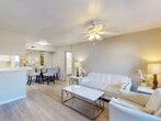 Located at 14531 Ella Blvd in Houston, TX, this 2-bedroom, 3-bathroom single-floor residence offers a well-organized and functional layout. The open-concept main living area seamlessly connects the living room, dining room, and kitchen, creating a bright and cohesive space. Light wood-look flooring flows throughout, complemented by neutral warm-toned walls and ceiling fans with integrated lighting in the main living areas and bedrooms. The living room features a sliding glass door that opens to a balcony, allowing natural light to fill the space. The galley-style kitchen is efficiently designed with white cabinetry, white countertops, a built-in sink, and black appliances including a refrigerator, electric range, and dishwasher. A pantry provides additional storage. The primary bedroom offers comfortable proportions, a ceiling fan, and access to a closet. Three well-appointed closets throughout the home, including a walk-in style with wire shelving, provide ample storage. The three bathrooms each feature tiled shower-tub combinations and light wood-look flooring. A dedicated laundry room houses a full-size washer and dryer with overhead wire shelving, adding everyday convenience to this practical and inviting Houston home.
