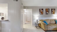 Located at 8917 S Gessner Rd in Houston, TX, this single-story, one-bedroom, one-bathroom unit offers a well-organized and functional layout across a compact but thoughtfully designed floor plan. Light-toned tile flooring runs throughout the entire space, creating a clean, cohesive aesthetic that reflects natural light from multiple windows.

The living room is comfortably sized, featuring neutral gray walls and windows that allow natural light to brighten the space. A hallway connects the living area to the rest of the unit, leading to the dining room, bedroom, and bathroom. The dining room is a standout area, boasting a large window with horizontal blinds, an elegant chandelier overhead, and direct visual access to the adjacent kitchen, which features a pass-through counter and pantry for added convenience.

The bedroom is generously proportioned, accommodating a full-sized bed with ease. It is equipped with a ceiling fan, a large sliding glass door fitted with vertical blinds, and access to what appears to be a back patio. Storage is well-addressed with two closets, including a spacious walk-in closet featuring built-in shelving and hanging rods.

The bathroom includes a full bathtub with tile surround, a toilet, and clean, neutral finishes. The overall ambiance of the unit is bright, tidy, and functional, with a neutral color palette that lends itself to easy personalization.