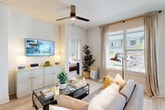 This thoughtfully designed 2-bedroom, 2-bathroom single-floor residence offers a comfortable and functional layout with a cohesive, modern aesthetic throughout. Light wood-style flooring flows through the main living areas, complemented by neutral-toned walls and black hardware accents that add a contemporary touch.

The open-concept kitchen is a standout feature, showcasing granite countertops, white upper cabinetry, gray lower cabinets, a subway tile backsplash, stainless steel appliances, and a central island with dramatic pendant lighting overhead. The adjacent dining area benefits from large windows dressed with linen curtains, filling the space with natural light. The living room is welcoming and spacious, featuring a ceiling fan, large windows with outdoor views, and easy access to the bedrooms via a clean, well-lit hallway.

The primary bedroom is a comfortable retreat with plush carpeting, a ceiling fan, ample natural light, and a private en-suite bathroom and walk-in closet. The second bedroom mirrors this comfortable style. Both bathrooms are well-finished, with one featuring a tub-shower combination, wood-look tile flooring, white cabinetry, and granite countertops. Additional storage is provided by multiple closets and hallway space, making this residence as practical as it is attractive.