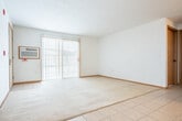 Located at 5097 N 28th Ave in Maine, WI, this single-floor, one-bedroom, one-bathroom unit offers a practical and well-organized layout. The open-concept living, dining, and kitchen area forms the heart of the home, with light tile flooring in the kitchen transitioning to carpet in the living space. The kitchen is outfitted with warm honey-toned wood cabinetry, white appliances including a range, dishwasher, microwave, and refrigerator, and a functional peninsula that separates it from the dining area. A chandelier adds a touch of character overhead. The living area is bright and open, benefiting from a sliding glass door with vertical blinds that invites natural light and provides outdoor access. A wall-mounted air conditioning unit ensures year-round comfort. The spacious bedroom features plush carpeting, a ceiling fan, and a window with natural light, along with access to a dedicated closet. The full bathroom includes a tub/shower combo, tile flooring, and a vanity with wood cabinetry. A dedicated laundry room with a full-size washer and dryer and overhead shelving adds significant everyday convenience. The unit also includes a hallway connecting all rooms for a cohesive and functional flow throughout.