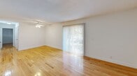 Located at 2700 Brigadoon Drive in Raleigh, NC, this well-appointed one-bedroom, one-bathroom residence offers a comfortable and functional single-floor layout. Warm hardwood flooring runs consistently throughout the space, lending a cohesive and inviting feel to every room.

The living room is generously sized and filled with natural light, thanks to a full-width sliding glass door fitted with vertical blinds that opens to an outdoor view. A ceiling fan adds to the room's practicality and comfort. The clean white walls and textured ceiling create a bright, airy atmosphere throughout.

The kitchen features white cabinetry with ample upper and lower storage, dark granite-style countertops, a double sink, and includes a full-size refrigerator and dishwasher. Light flooring complements the crisp cabinetry for a clean, functional workspace.

The bedroom is a comfortable size, with a window allowing natural light to filter in. It includes direct access to a spacious walk-in closet outfitted with dual shelving rods and built-in shelves, providing abundant storage.

The bathroom is neatly finished with a white vanity, dark countertop, framed mirror, brushed nickel fixtures, and hardwood-style flooring, offering a clean and polished look. The layout is efficient and well-organized throughout.