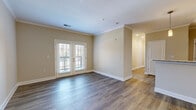 Located in Murfreesboro, TN, this 2-bedroom, 1-bathroom residence offers a well-designed single-floor layout that balances comfort and functionality. The living room is a welcoming focal point, featuring rich hardwood-style flooring, crown molding, and a set of French doors that invite natural light and provide outdoor views. The entry area continues the hardwood-style flooring and is framed with clean crown molding details.

The kitchen is a standout feature, showcasing rich dark wood cabinetry, stainless steel appliances including a refrigerator, range, microwave, and dishwasher, complemented by granite countertops and a subway tile backsplash. Pendant lighting adds a polished touch over the kitchen workspace.

Both bedrooms are carpeted and well-lit, with the primary bedroom offering a ceiling fan, a large window with outdoor views, and access to a walk-in closet outfitted with multi-tiered wire shelving. The second bedroom also features plush carpet and a generous window with natural light.

The bathroom is cleanly finished with a granite-top vanity, dark wood cabinetry, a large mirror, and a full tub-shower combination with tile surround. Wood-look flooring completes the space with a cohesive, modern aesthetic throughout.