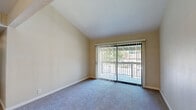 Located at 8079 Sunrise East Way in Citrus Heights, CA, this two-bedroom, two-bathroom unit offers a functional and comfortable single-floor layout. The living area features vaulted ceilings that enhance the sense of openness, soft carpeting underfoot, and a sliding glass door that opens to a private balcony with views of surrounding greenery, allowing natural light to fill the space.

The kitchen is well-appointed with white cabinetry, granite-look countertops, a double-basin sink, wood-look vinyl flooring, and black appliances including a range and refrigerator. A dedicated pantry closet adds convenient storage.

The primary bedroom is a comfortable size and includes a walk-in closet with built-in shelving and hanging rods. The second bedroom also features plush carpeting, a window with blinds for natural light, and a sliding-door closet with a hanging rod. Each bathroom is clean and functional — one features a wide vanity with granite-look countertops and ample cabinet storage, while the other includes a full soaking tub and shower combination. Wood-look flooring runs through the bathrooms, complementing the overall neutral color palette found throughout the unit. A hallway connects all rooms, contributing to an efficient and practical floor plan.