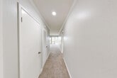 Located at 2905 Clairemont Drive in San Diego, CA, this two-bedroom, one-bathroom residence offers a comfortable and functional single-floor layout. The combined living and dining area is bright and open, featuring soft carpeting, crown molding, a ceiling fan, and a distinctive painted brick accent wall. A sliding glass door leads to a private balcony, allowing natural light to flow into the space and providing outdoor views of the surrounding neighborhood.

The kitchen is equipped with warm wood cabinetry, granite-style countertops, a gas range, dishwasher, and full-size refrigerator, all set on durable tile flooring. A window above the sink brings in additional natural light.

Both bedrooms are carpeted and feature ceiling fans and shiplap-style accent walls. The primary bedroom includes a sliding closet and direct access to the balcony, while the second bedroom offers a closet and a bright window with vertical blinds. The unit includes three closets in total, providing ample storage throughout.

The bathroom features a clean, full-size tub and shower combo with sliding glass doors. Connecting the rooms, the hallways are bright with recessed lighting and crown molding details. A utility room completes the layout, adding practical functionality to this well-organized Clairemont residence.