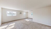 Located at 944 Station Ave in Bensalem, PA, this 2-bedroom, 1-bathroom unit offers a practical and well-organized single-floor layout. The combined kitchen and living area serves as the heart of the home, featuring light wood-look vinyl flooring that runs throughout. The kitchen is equipped with rich dark wood cabinetry, granite-style countertops, a stainless steel gas range, and a full-size stainless steel refrigerator, providing ample functionality for everyday cooking. Natural light enters through multiple windows, brightening the open living space. The primary bedroom is generously sized, offering two windows with outdoor views, plush wall-to-wall carpeting, a baseboard heating system, and a large sliding-door closet. The second bedroom is similarly carpeted and well-lit, also featuring baseboard heat and a window. Both bedrooms provide a quiet, comfortable atmosphere. The full bathroom includes a shower/tub combination, toilet, and vanity, finished with the same wood-look vinyl flooring found in the main living areas. A wall-mounted air conditioning unit in the living area and baseboard heating throughout ensure year-round comfort. Clean white walls and neutral finishes give the space a bright, move-in ready feel.