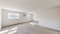 Located at 944 Station Ave in Bensalem, PA, this 2-bedroom, 1-bathroom unit offers a practical and well-organized single-floor layout. The combined kitchen and living area serves as the heart of the home, featuring light wood-look vinyl flooring that runs throughout. The kitchen is equipped with rich dark wood cabinetry, granite-style countertops, a stainless steel gas range, and a full-size stainless steel refrigerator, providing ample functionality for everyday cooking. Natural light enters through multiple windows, brightening the open living space. The primary bedroom is generously sized, offering two windows with outdoor views, plush wall-to-wall carpeting, a baseboard heating system, and a large sliding-door closet. The second bedroom is similarly carpeted and well-lit, also featuring baseboard heat and a window. Both bedrooms provide a quiet, comfortable atmosphere. The full bathroom includes a shower/tub combination, toilet, and vanity, finished with the same wood-look vinyl flooring found in the main living areas. A wall-mounted air conditioning unit in the living area and baseboard heating throughout ensure year-round comfort. Clean white walls and neutral finishes give the space a bright, move-in ready feel.