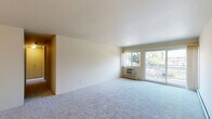 Located at 3134 Greenfield Rd in Royal Oak, Michigan, this two-bedroom, one-bathroom residence offers a well-organized single-floor layout with a comfortable and functional design. The spacious living room is carpeted and filled with natural light from a large sliding glass door that opens onto a private balcony, offering pleasant outdoor views of the surrounding neighborhood. A wall-unit HVAC system and baseboard heating ensure year-round comfort throughout the home.

The kitchen features light wood laminate flooring, granite countertops, ample cabinetry, a dishwasher, and an electric range — all illuminated by overhead lighting. An adjacent pantry provides additional storage. The kitchen flows naturally into the dining area, creating an open and convenient layout for daily living.

Both bedrooms are carpeted and receive natural light through windows with neighborhood views. The generously sized primary bedroom is complemented by multiple closets, including walk-in style closets with built-in shelving — providing exceptional storage. A central hallway connects the private areas of the home.

The bathroom is appointed with large marble-style tile surrounding a full soaking tub and shower, complemented by granite countertops on the vanity and neutral tile flooring. With four closets total, this residence offers notable storage capacity throughout.