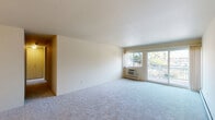 Located at 3134 Greenfield Rd in Royal Oak, Michigan, this two-bedroom, one-bathroom residence offers a well-organized single-floor layout with a comfortable and functional design. The spacious living room is carpeted and filled with natural light from a large sliding glass door that opens onto a private balcony, offering pleasant outdoor views of the surrounding neighborhood. A wall-unit HVAC system and baseboard heating ensure year-round comfort throughout the home.

The kitchen features light wood laminate flooring, granite countertops, ample cabinetry, a dishwasher, and an electric range — all illuminated by overhead lighting. An adjacent pantry provides additional storage. The kitchen flows naturally into the dining area, creating an open and convenient layout for daily living.

Both bedrooms are carpeted and receive natural light through windows with neighborhood views. The generously sized primary bedroom is complemented by multiple closets, including walk-in style closets with built-in shelving — providing exceptional storage. A central hallway connects the private areas of the home.

The bathroom is appointed with large marble-style tile surrounding a full soaking tub and shower, complemented by granite countertops on the vanity and neutral tile flooring. With four closets total, this residence offers notable storage capacity throughout.