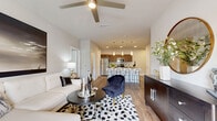 This thoughtfully designed 2-bedroom, 2-bathroom residence offers a functional and modern single-floor layout with hardwood-style flooring throughout. The open-concept living and kitchen area serves as the heart of the home, featuring a ceiling fan, abundant recessed lighting, and direct access to a private patio through glass doors that invite natural light into the space.

The kitchen is well-equipped with rich walnut-toned cabinetry, granite countertops, a tiled backsplash, stainless steel appliances including a range, microwave, refrigerator, and dishwasher, plus an island with pendant lighting and bar seating — ideal for both cooking and casual dining. A pantry and dedicated laundry room with full-size washer and dryer add everyday convenience.

Both bedrooms are comfortably sized, featuring ceiling fans, large windows with natural light, and ample closet space. The primary bedroom offers a generous footprint with room for a king-size bed and additional furnishings. Each bathroom is finished with granite-topped wood-toned vanities, large-format tile tub/shower surrounds, and hardwood-style flooring. With five closets total, storage is plentiful throughout this efficiently designed and attractively finished residence.