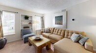This single-floor residence at 4133 Arbor Dr in Shrewsbury, Massachusetts offers a well-organized layout that balances comfort and functionality. The living room serves as the heart of the home, featuring plush carpeting, a textured ceiling, built-in shelving, and ample space for both relaxing and entertaining. Natural light filters in through a window dressed with patterned curtains, creating a warm and inviting atmosphere.

Adjacent to the living area, a dedicated dining space connects seamlessly to the kitchen, which is outfitted with rich, dark wood cabinetry, granite-style countertops, stainless steel appliances including a refrigerator, gas range, and over-the-range microwave, and durable tile flooring — offering both style and practicality.

The bedroom is generously proportioned with soft carpeting underfoot and features sliding glass doors that open directly to a private outdoor patio, providing access to natural light and outdoor views. The room is further complemented by a spacious feel enhanced by vertical blinds and tasteful framed artwork.

The full bathroom is cleanly finished with tile flooring, white subway-tiled tub and shower surround with a decorative accent border, a vanity with ample storage, and bright, neutral tones throughout. An additional room provides versatile space suitable for use as a home office or den.