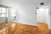 Located at 291 Avenue Rd, Suite 507, in Toronto's sought-after Summerhill neighbourhood, this one-bedroom, one-bathroom unit offers a compact and efficiently designed layout across a single floor. Warm parquet hardwood flooring runs throughout the living and bedroom areas, adding a classic character to the space. The bedroom is generously proportioned relative to the overall footprint, featuring a wide window that draws in natural light and offers views of the surrounding neighbourhood. The kitchen is bright and well-appointed, showcasing white shaker-style cabinetry with brushed nickel hardware, marble-patterned countertops, a white tile backsplash, and light tile flooring — creating a clean, modern aesthetic. The bathroom is finished in an all-white palette with a full bathtub and shower combination, a vanity with storage, and tile walls, lending a crisp and functional feel. The main living area benefits from the same warm parquet flooring, white walls, and clear sightlines to both the entry and interior rooms, making the space feel open and organized. Overall, this unit presents a bright, clean, and practical living space well-suited for those seeking a manageable footprint in a prime Toronto location.