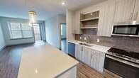This contemporary apartment offers a well-designed living space of 840 square feet, comprising two bedrooms and one bathroom. The open-concept layout creates a sense of spaciousness, with the living room seamlessly flowing into the kitchen area. Large windows in the living room and bedrooms allow for ample natural light, enhancing the bright and airy atmosphere.

The kitchen is a highlight, featuring modern light-wood cabinetry, stainless steel appliances, and a stylish brown subway tile backsplash. Quartz countertops provide both durability and elegance. The primary bedroom, measuring 160 square feet, offers generous space and includes a walk-in closet with custom shelving.

Throughout the apartment, warm-toned hardwood flooring adds a touch of sophistication and continuity. The bathroom is well-appointed with a combination tub-shower, modern vanity, and ceramic tile flooring. Additional storage is provided by a hallway closet.

Located at 13280 Woodland Park Rd in Herndon, VA, this apartment combines comfort and style in a convenient location. The neutral color palette and clean lines create a canvas for personalization, making this space an ideal home for modern living.