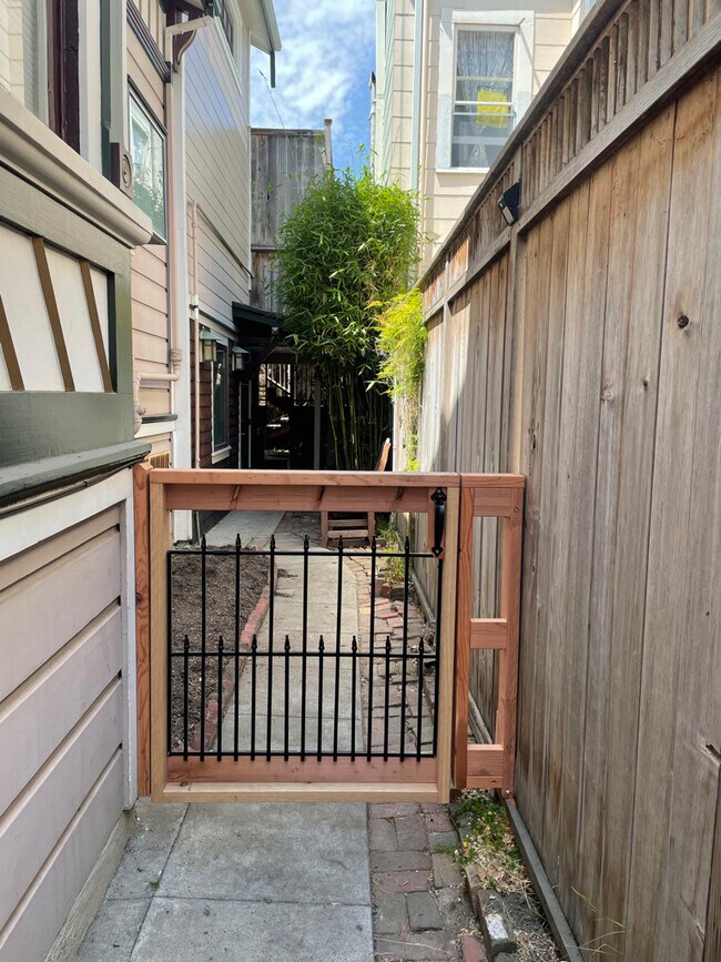 The gate on the side yard that leads to the apartmment - 1539 Fairview St