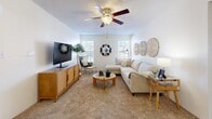 Located at 345 Shadow Mountain Dr in El Paso, TX, this two-bedroom, one-bathroom residence offers a comfortable and efficiently designed single-floor layout. The bright living room features plush carpeting, a ceiling fan with light fixture, a textured ceiling, and multiple windows that allow natural light to fill the space, creating a warm and inviting atmosphere. The open flow connects the living area to a combined dining room and kitchen, making the space feel connected and functional. The galley-style kitchen is well-appointed with cream cabinetry, light countertops, hardwood-style flooring, and black stainless appliances including a range, microwave, refrigerator, and dishwasher. A pendant-lit dining area sits adjacent, ideal for everyday meals. The primary bedroom offers generous proportions, carpeted floors, a ceiling fan, natural window light, and a mirrored sliding-door closet. A second bedroom and an additional closet provide flexible storage options. The full bathroom features hardwood-style flooring, a vanity with cabinetry, and a tiled tub-shower combination. A private balcony with a wood-plank deck and lattice railing offers an outdoor retreat with views of the surrounding landscape.