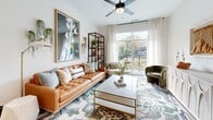 Located in Atlanta's vibrant Briarcliff corridor, this thoughtfully designed 2-bedroom, 3-bathroom single-floor residence offers a seamless blend of modern aesthetics and functional living. Hardwood-style flooring flows throughout, tying each space together cohesively.

The kitchen is a standout feature, boasting two-tone cabinetry — natural wood uppers paired with sage-blue lowers — complemented by a classic subway tile backsplash, stainless steel appliances, and a generous island with seating. A statement pendant chandelier adds a refined finishing touch.

The living room is bright and airy, with large sliding glass doors that open to a private balcony offering open outdoor views. A ceiling fan and neutral palette keep the space feeling open and inviting.

The primary bedroom features a dramatic accent wall, natural light from a large window with outdoor views, and an en-suite bathroom equipped with a dual-sink vanity with wood cabinetry, illuminated mirrors, matte black fixtures, and a soaking tub surrounded by marble-style tile. The second bedroom is equally well-appointed with its own en-suite bath, ceiling fan, and tranquil natural light. Two closets and dual hallways provide practical storage and easy circulation throughout the residence.