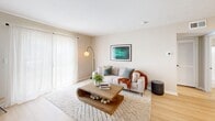 Located at 4705 Windsong Dr in Virginia Beach, VA, this thoughtfully designed one-bedroom, one-bathroom residence offers a comfortable and efficient single-floor layout. The living room welcomes you with light wood-style flooring, neutral walls, and a sliding glass door dressed in sheer curtains that allow natural light to fill the space, creating an airy and inviting atmosphere. A dedicated entryway with a wall-mounted coat hook adds everyday convenience. The kitchen features crisp white shaker cabinetry, granite-style countertops, a stainless steel dishwasher, and a light-filled dining area — ideal for both cooking and casual meals. The bedroom is a calm retreat finished with plush carpet, a natural light-filled window with drapes, and direct access to a walk-in closet with built-in shelving. The laundry area, conveniently tucked within the unit, includes a stacked washer and dryer alongside additional storage. The bathroom offers a full tub-shower combination with clean, classic finishes. Throughout, the residence maintains a cohesive neutral palette and modern sensibility, making it a comfortable and practical home in a coastal Virginia Beach location.