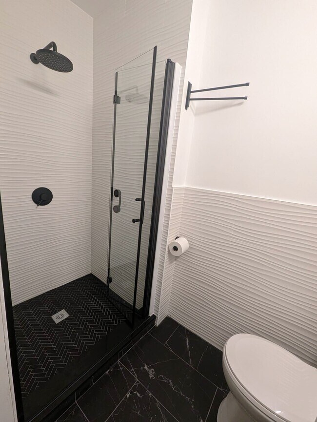 Renovated Bathroom has modern fixtures and a stylish design - 162 27th St