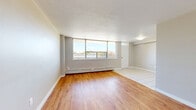 Located on the third floor at 11 Kendale Crt in Hamilton, Ontario, this 2-bedroom, 1-bathroom unit offers a practical and comfortable single-floor layout. The open-concept living and kitchen area transitions seamlessly between light tile flooring near the kitchen — where a white refrigerator is visible — and warm hardwood flooring extending throughout the living space and bedrooms. Neutral grey walls and clean white baseboards create a bright, cohesive aesthetic throughout.

The generously sized primary bedroom is a standout feature of the unit, offering ample space along with a large window that frames views of mature trees, filling the room with natural light. A baseboard heating unit ensures year-round comfort. The second bedroom is also well-proportioned, featuring the same warm hardwood floors, a window, and a double-door closet providing convenient storage.

The bathroom is functional and clean, featuring tile flooring, a wide countertop surface, an under-sink vanity, and a mirrored medicine cabinet above. The overall design of the unit is understated and neutral, offering a versatile canvas well-suited to a variety of interior styles. This unit provides a comfortable and efficient living space in a residential Hamilton neighbourhood.